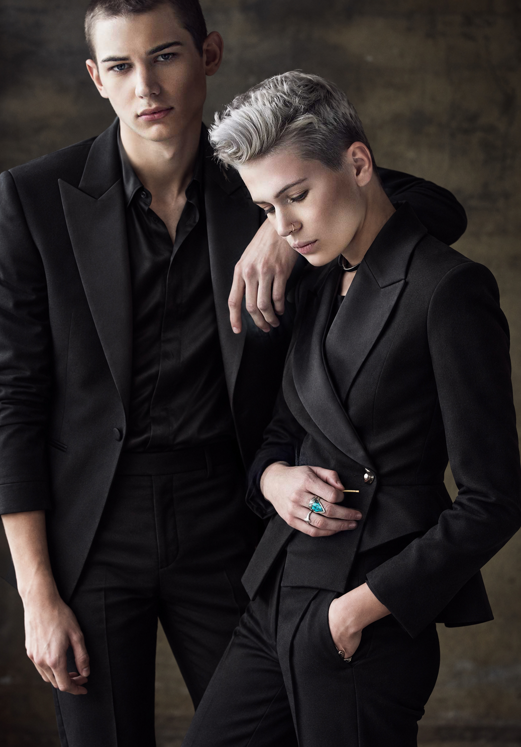 Studio portrait of two people in black suits