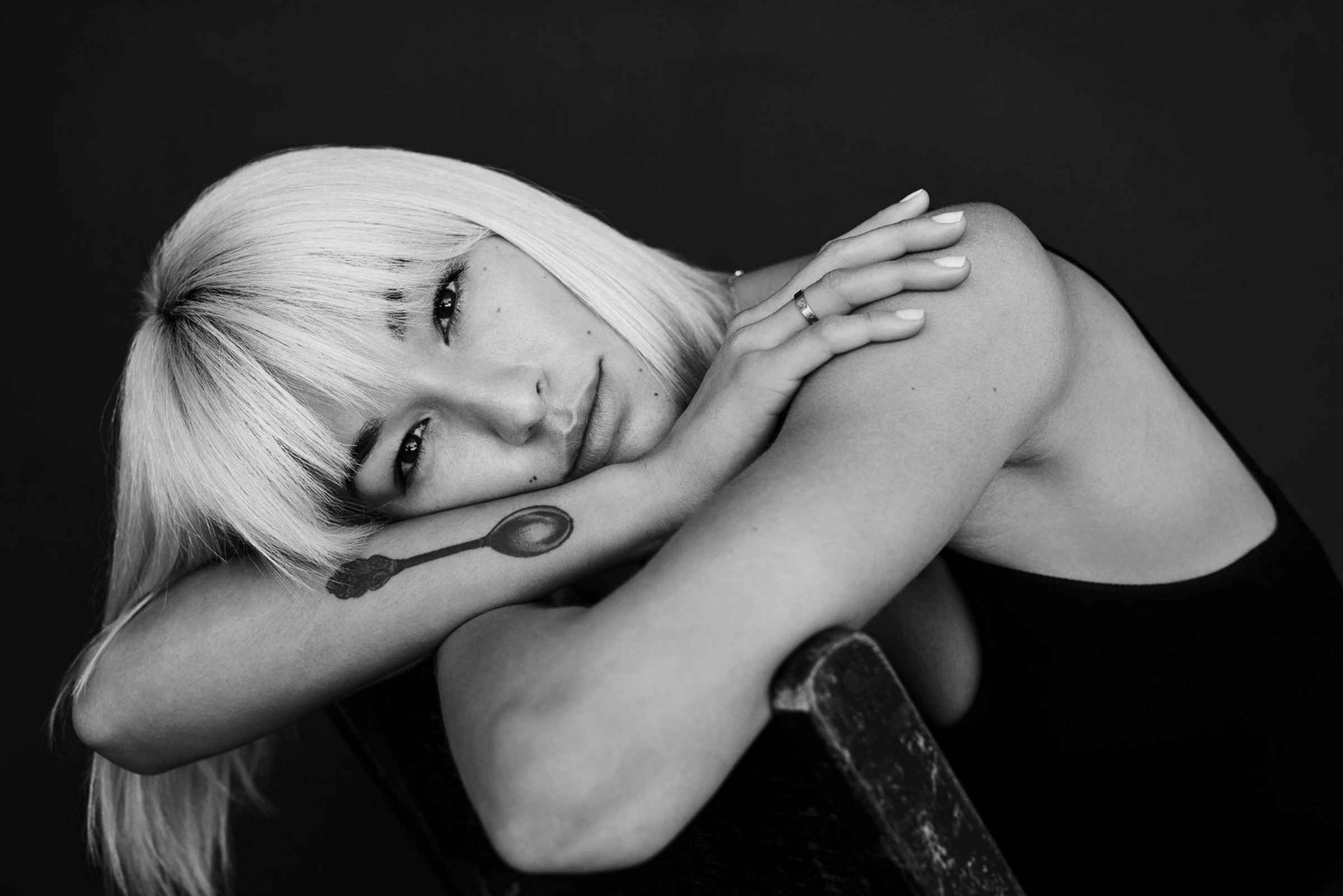 Black and white portrait resting on folded arms